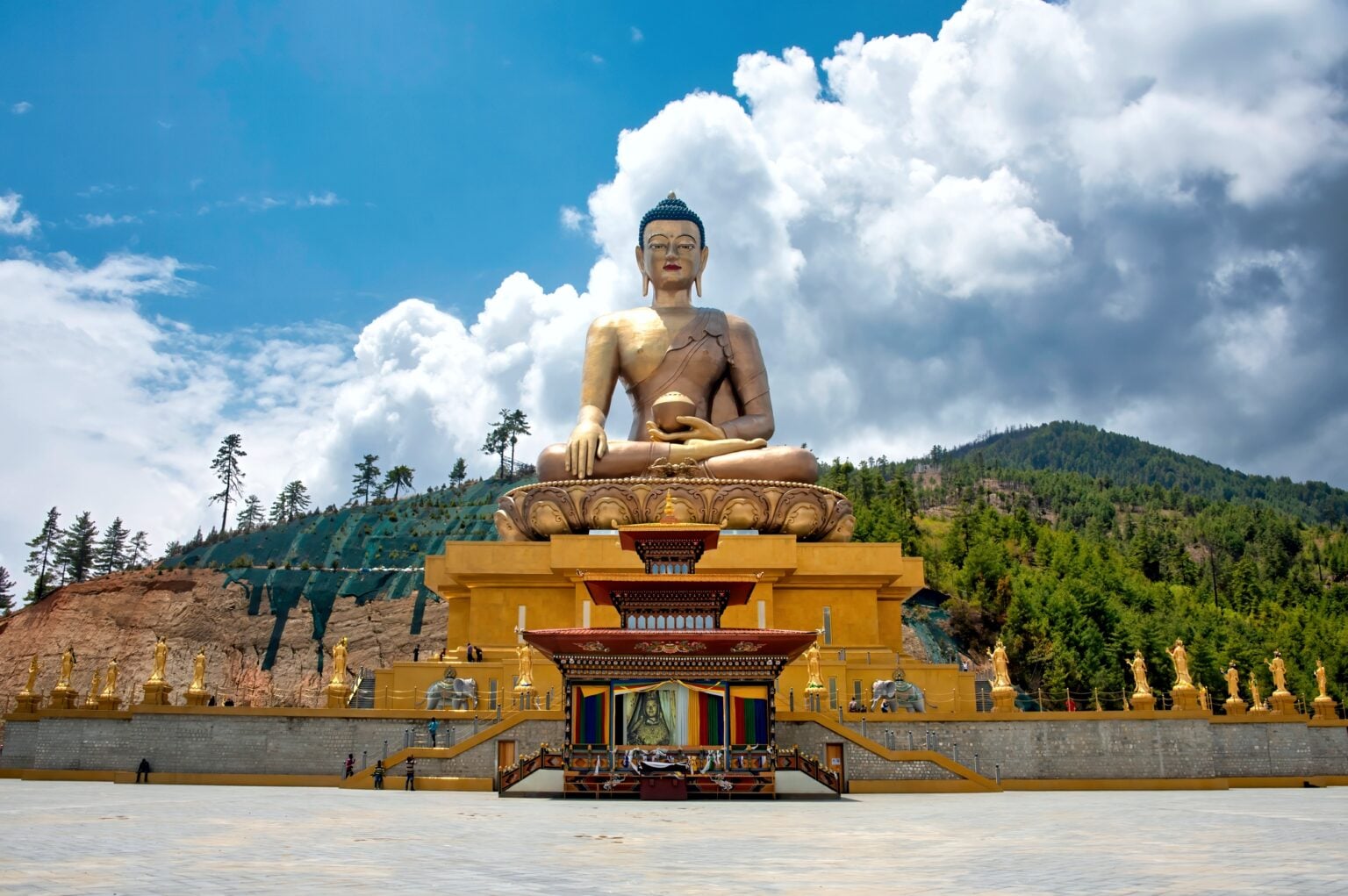 Buddha Dordenma, Thimpu, Bhutan – April 28, 2018 - gigantic Shakyamuni, golden statue of Buddha sitting atop a gilded meditation hall under a bright blue sky in the capital city of Bhutan