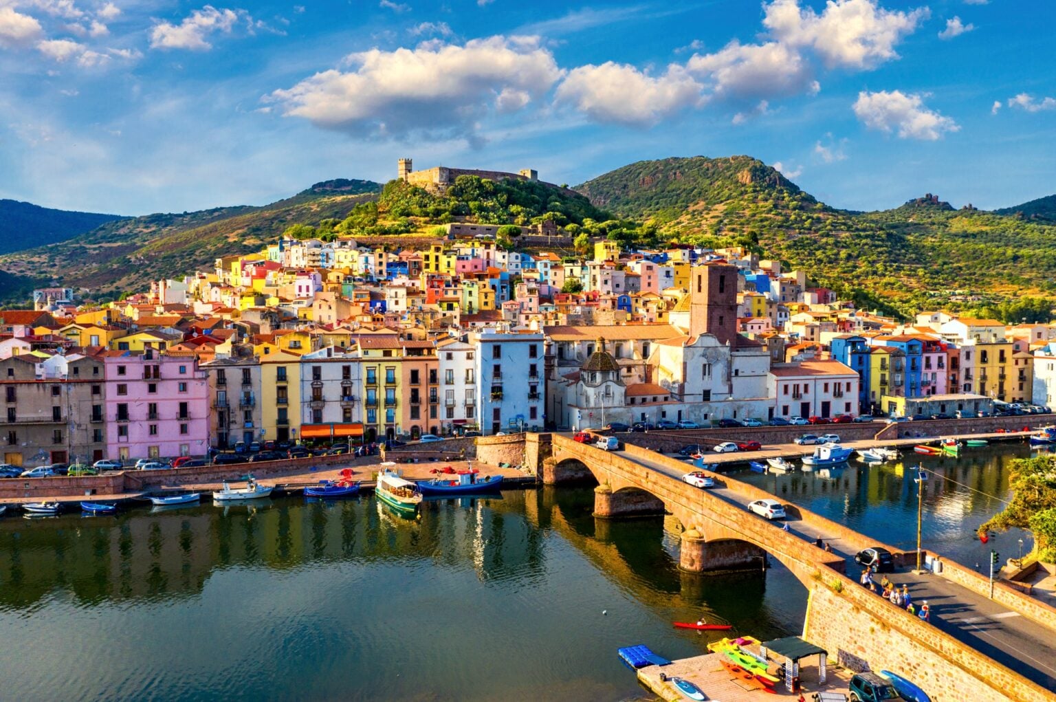 Aerial view of the beautiful village of Bosa with colored houses and a medieval castle. Bosa is located in the north-wesh of Sardinia, Italy. Aerial view of colorful houses in Bosa village, Sardegna.