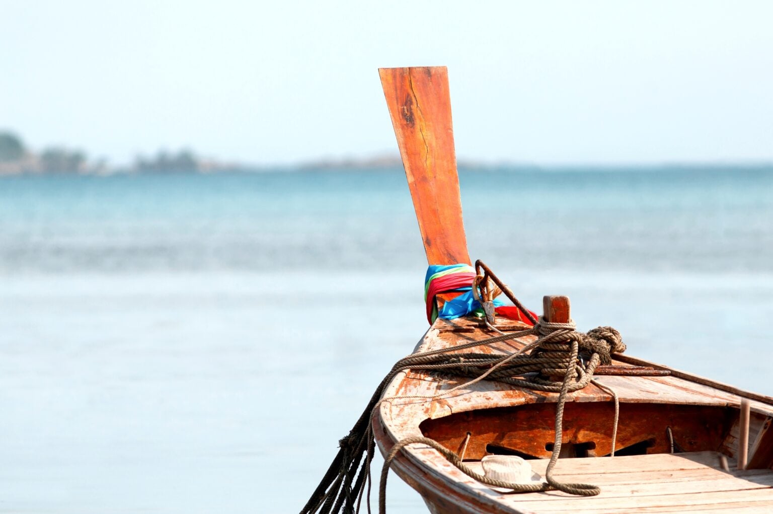 Closeup of national Thai Taxi Boat. Traditional Thailand wooden long tail boat in a tropical bay, Andaman sea on background, copy space. Summer vacation concept