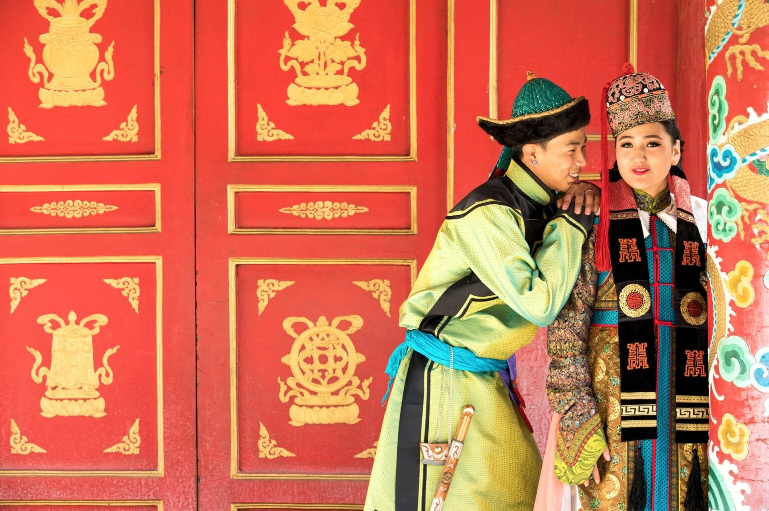 Young Mongolian couple in a traditional 13th century costume in a temple. Ulaanbaatar, Mongolia.