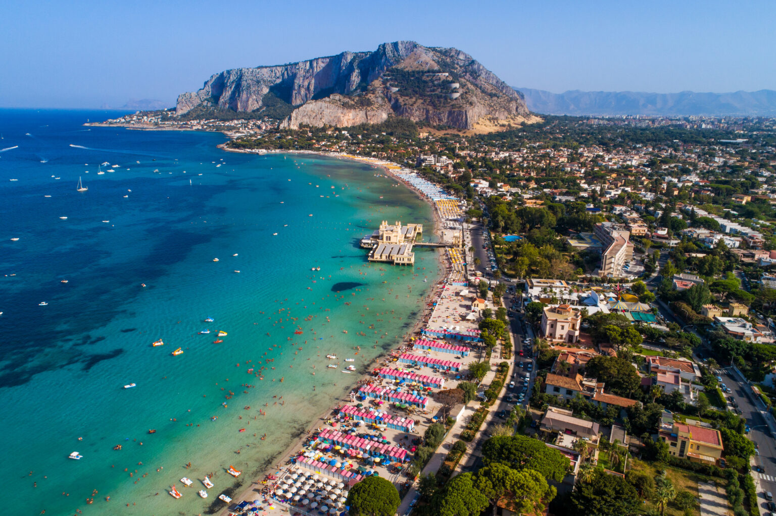 Palermo, Sicily, Italy - August 8, 2017: view showing Sicily island, boats in the sea, trees, buildings and mountains can be seen on the background